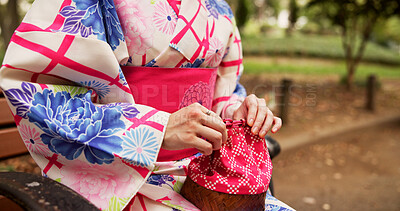 Buy stock photo Woman, hands and kimono in park with bag, traditional fashion and relax with indigenous style in Japan. Girl, purse and outdoor in Tokyo with culture, drawstring kago and elegant aesthetic on bench