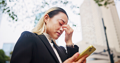 Buy stock photo Frustrated, asian woman or phone with headache in city for company bankruptcy, debt or mistake. Japan, female person or employee with migraine or mobile smartphone in strain, financial crisis or fail