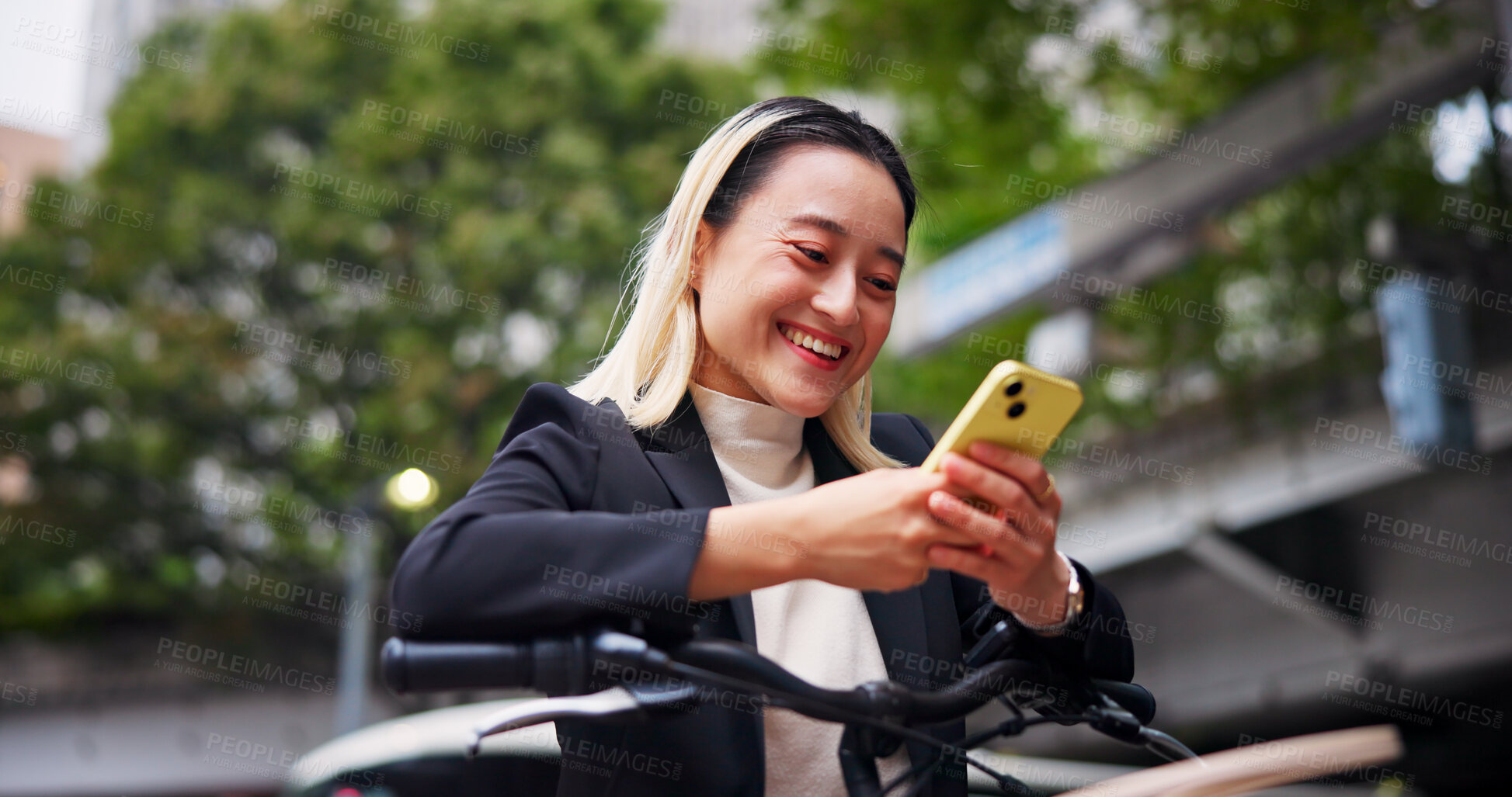 Buy stock photo Phone, bicycle and happy business woman on chat app, email and cycling on commute to work in Japan. Mobile, smile or person on bike in city to travel on sustainable transport, text or reading message