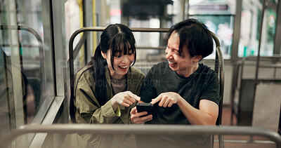 Buy stock photo Couple, happy and travel in cable car with phone for funny social media meme, laughing and pointing to comic video. Explore, japanese people and surprised for online gossip and adventure in transport