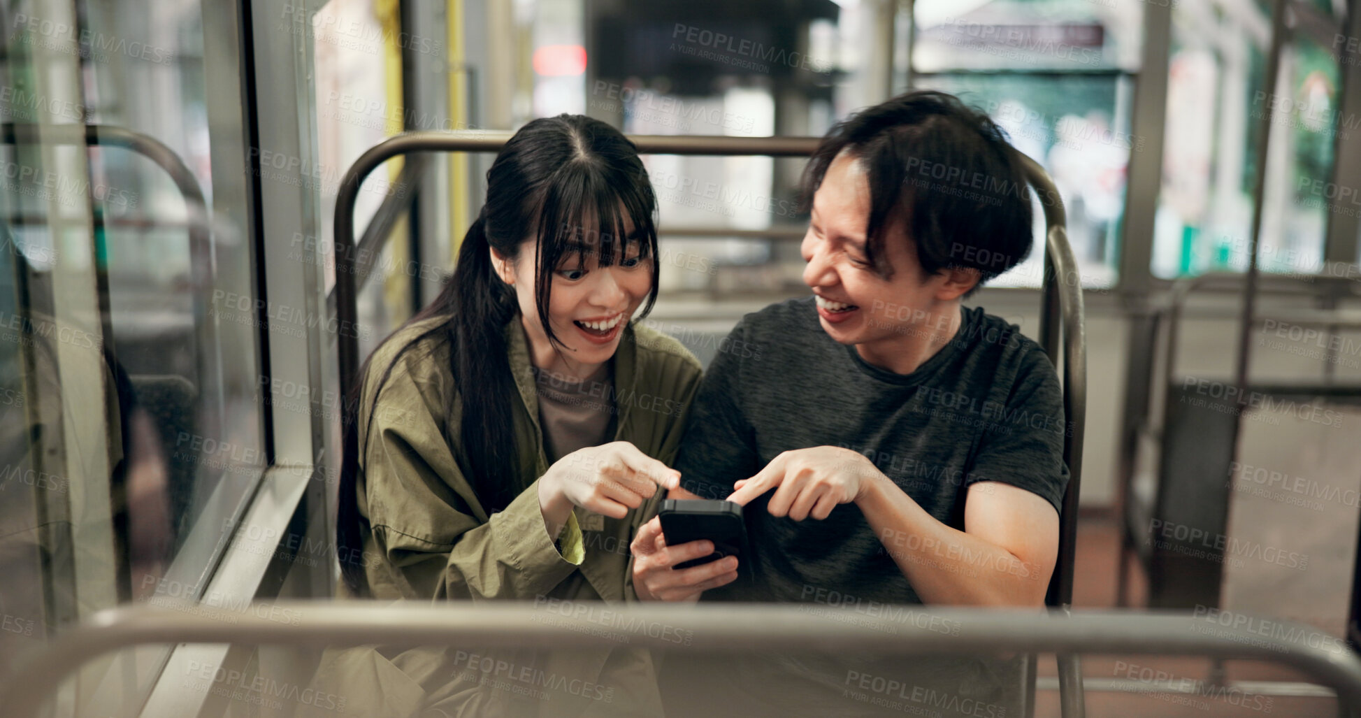 Buy stock photo Couple, happy and travel in cable car with phone for funny social media meme, laughing and pointing to comic video. Explore, japanese people and surprised for online gossip and adventure in transport