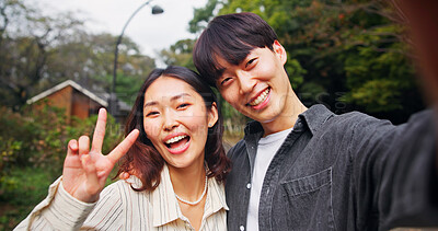 Buy stock photo Portrait, peace sign and selfie of happy couple outdoor on date for love, laugh and photography together in Japan. Face, man and woman with v hand gesture for romantic connection, picture or memory