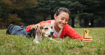 Selfie, outdoor and woman relaxing with dog for memory, social media or online post in woods. Happy, bonding and Japanese female person on grass with beagle puppy for photography picture in nature.