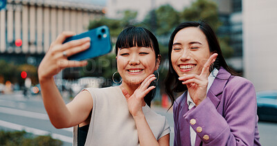Buy stock photo Business women, selfie and together in city with smile for peace sign, partner or excited for post on web. People, partnership and photography with laugh, happy or emoji with profile picture in Japan