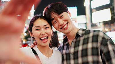 Buy stock photo Face, night and selfie with couple in city together in Japan for bonding, love or tourism. Photograph, portrait and smile of Japanese woman with man on urban street for holiday, travel or vacation