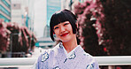Asian, happy woman and portrait with kimono in city for fashion, festival or tradition. Japan, female person or face with smile or outfit for culture, heritage or travel in an urban town of Tokyo