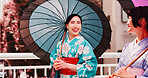 Urban, umbrella and girl friends in kimono walking on bridge for chat, morning travel or sightseeing together. City, fashion and Japanese women with traditional clothes, parasol or culture on commute