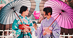 City, umbrella and friends in kimono with phone, smile or sightseeing on happy travel together. Urban fashion, culture and Japanese women in traditional clothes, parasol or mobile app for online chat