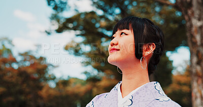 Buy stock photo Green, park and woman in kimono with smile, thinking and relax for outdoor sightseeing adventure in nature. Culture, inspiration and Japanese girl in garden for traditional spring festival with trees