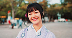 Japanese, happy woman and portrait with kimono in city for fashion, festival or tradition. Young, female person or face with smile or outfit for culture, heritage or travel in an urban town of Tokyo