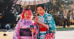 Phone, umbrella and Japanese women in park with smile, kimono and outdoor adventure together. Nature, culture and happy girl friends with traditional clothes, parasol or mobile app for online chat