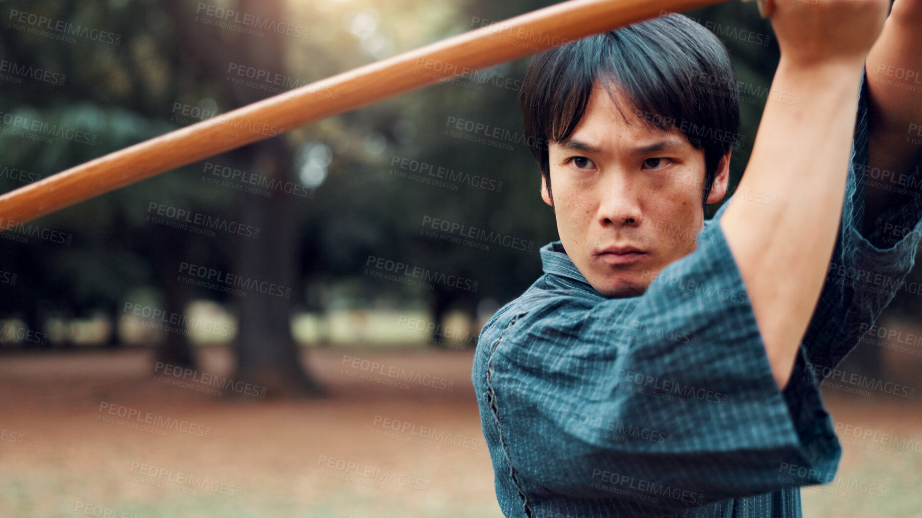 Buy stock photo Bokken, Japanese man and outdoor for martial arts in training, exercise and sports as athlete. Male person, culture and ready with bamboo sword, combat and practice for defense technique with bojutsu