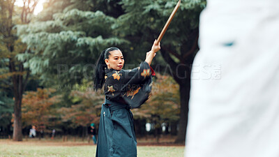 Buy stock photo Wooden sword, Japanese woman and outdoor in training, exercise and sports for martial arts or aikido. Students, weapon and heritage with challenge, combat and practice as defense technique or bojutsu