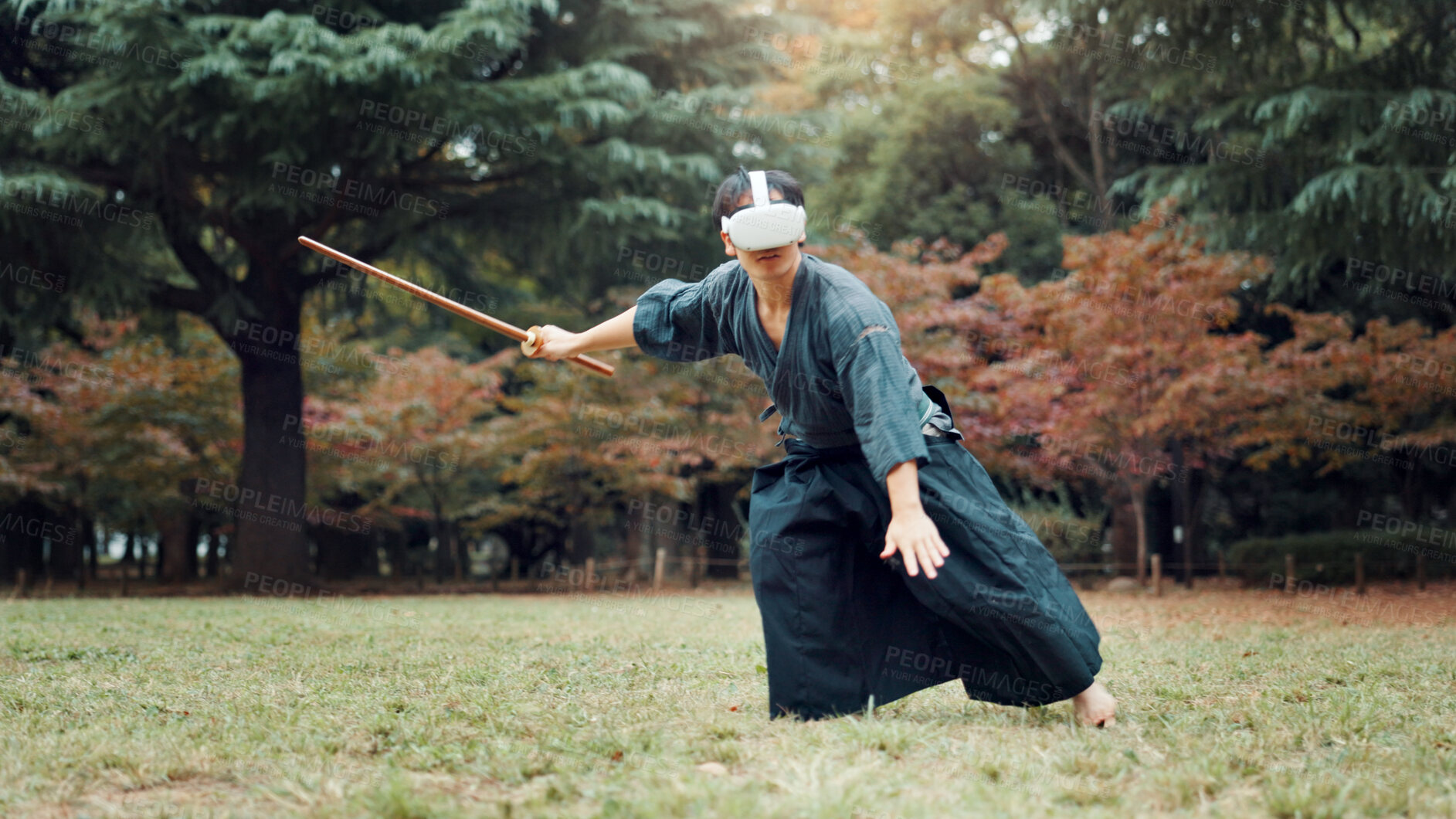 Buy stock photo Virtual reality, park and Asian man with bamboo sword for martial arts, Kendo practice and exercise. Culture, Japan heritage and person with shinai, VR tech and goggles for skills, fight and training