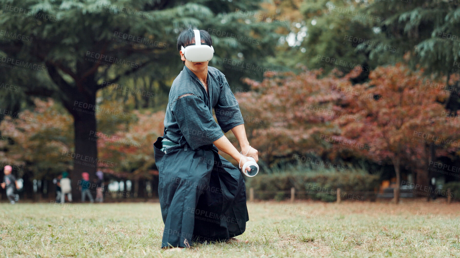 Buy stock photo Virtual reality, park and Asian man with controller for martial arts, Kendo practice and exercise. Metaverse, Japan culture and person with shinai, VR tech and goggles for skill, fight and training