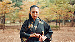 Portrait, serious and woman with kimono, martial arts and weapon for training, fighter and aikido. Woods, fitness and person with skills for bamboo sword, technique and discipline for kendo in Japan