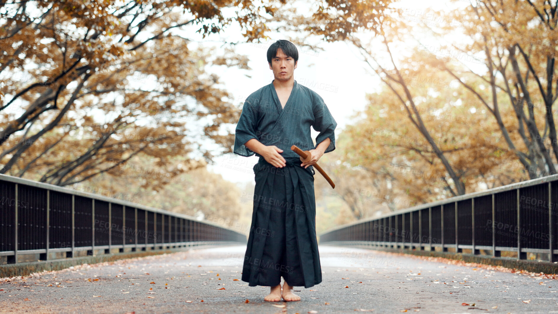 Buy stock photo Martial arts, man and sword outdoor with fight, battle and samurai training on city road. Park, urban and challenge with bamboo weapon, kendo and warrior in autumn in Japan with forest and fighter