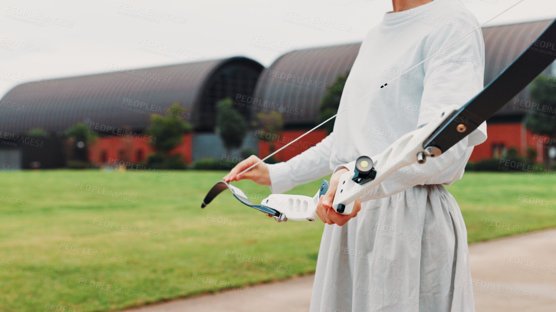 Buy stock photo Archery, sport and hands with bow outdoor for shooting practice, martial arts tradition or getting ready. Japanese culture, person and equipment safety for kyudo, precision lesson and start training