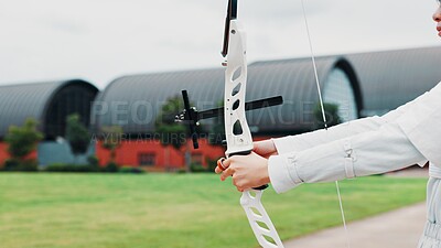 Buy stock photo Woman, hands and prepare bow for archery training at academy, outdoor exercise and aim. Female person, shooting challenge and field for competition games, learning and practice with tool in japan