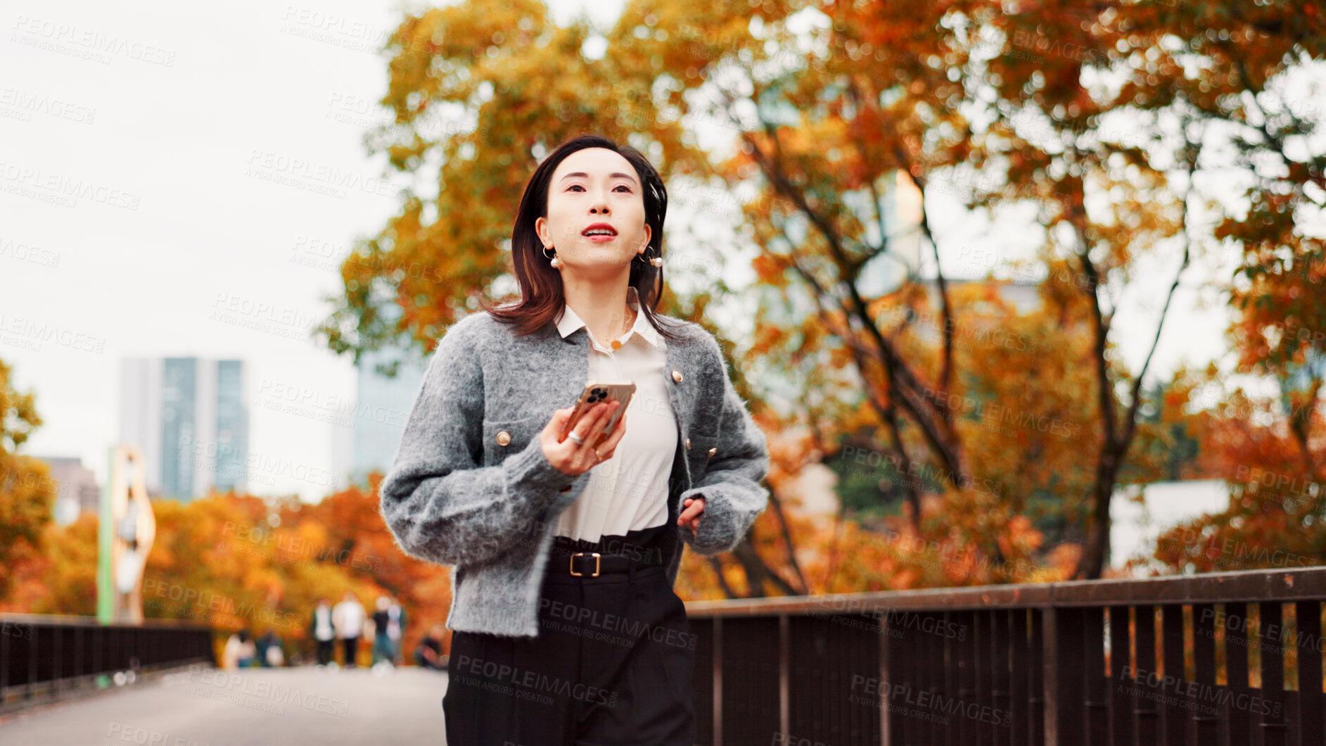 Buy stock photo Phone, late woman and running on park bridge checking time with rush for job in city. Japanese person, professional stress and schedule issue with work, appointment and overtime for autumn morning