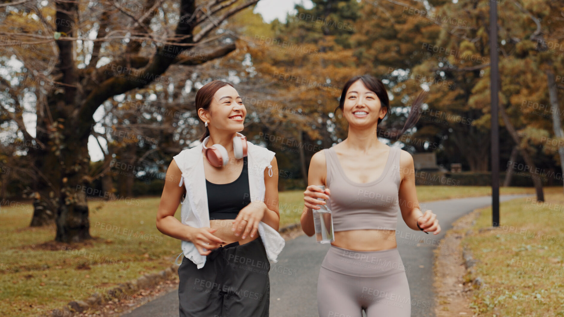 Buy stock photo Women, running and exercise for fitness, cardio and training for body goals, wellness or active in morning. Outdoor, smile and workout for Japanese friends, health and bonding together for routine