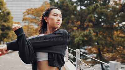 Buy stock photo Woman, running and warm up for fitness in city, stretching arms and outdoor nature for thinking. Female person, urban park and reflection on exercise preparation, getting ready and workout in Japan