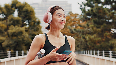 Buy stock photo Thinking, woman and headphones with fitness in city, listening to music and sports podcast. Female athlete, phone and streaming radio with exercise routine, training website and break on Japan bridge