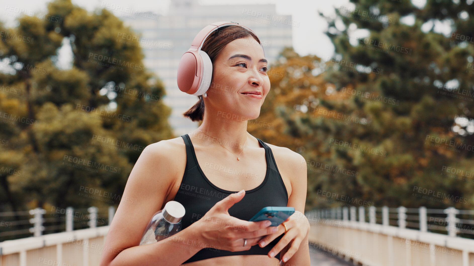 Buy stock photo Thinking, woman and headphones with fitness in city, listening to music and sports podcast. Female athlete, phone and streaming radio with exercise routine, training website and break on Japan bridge