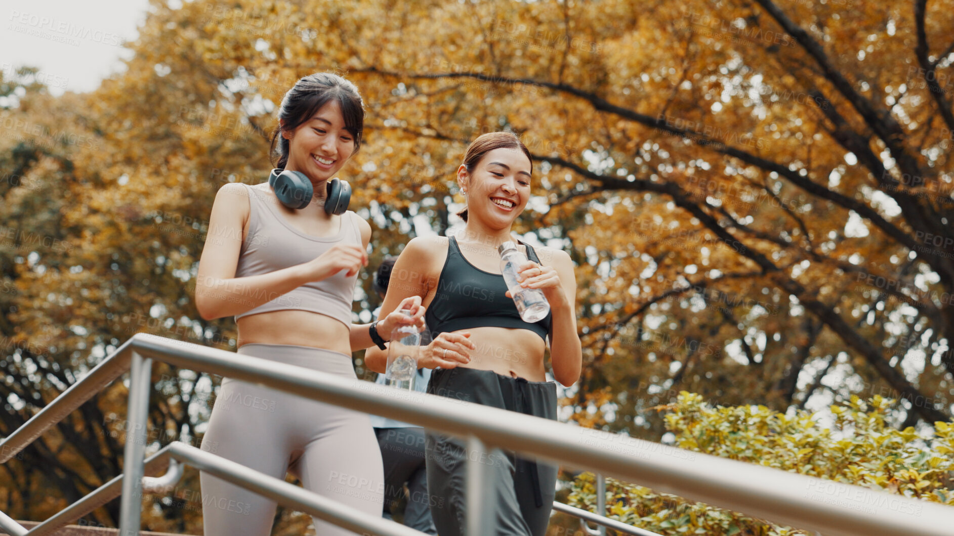 Buy stock photo Running, exercise and fitness for women, steps and friends with water, smile and active in morning. Outdoor, personal trainer and routine with Asian person, stairs and practice for marathon in Japan