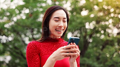 Buy stock photo Woman, phone and texting at park, happy and laugh at funny meme, notification or chat on mobile app in summer. Person, smartphone and smile in garden for contact, video and social network in Japan