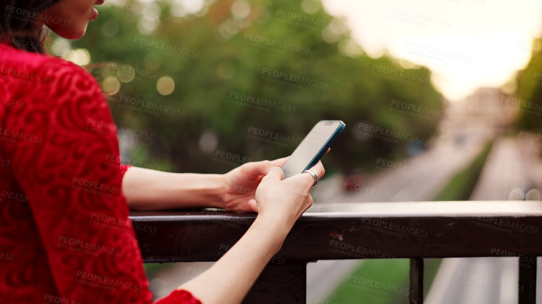 Buy stock photo Hands, phone and texting on bridge, nature and outdoor for notification, chat and mobile app by fence in city. Person, smartphone and scroll in town for contact, internet and social network in Japan