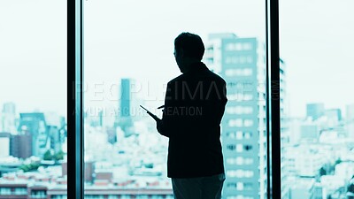 Buy stock photo Businessman, tablet or silhouette at window for research, planning or feedback in Japanese company. Finance investor, tech or online in office for banking, stock market news or investment opportunity