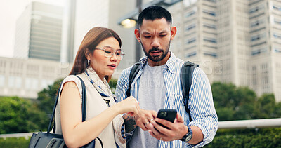 Buy stock photo Couple, phone and travel with direction in city, click and mobile app for location, landmark and help in street. People, man and woman with smartphone, talking and search on urban sidewalk in Japan