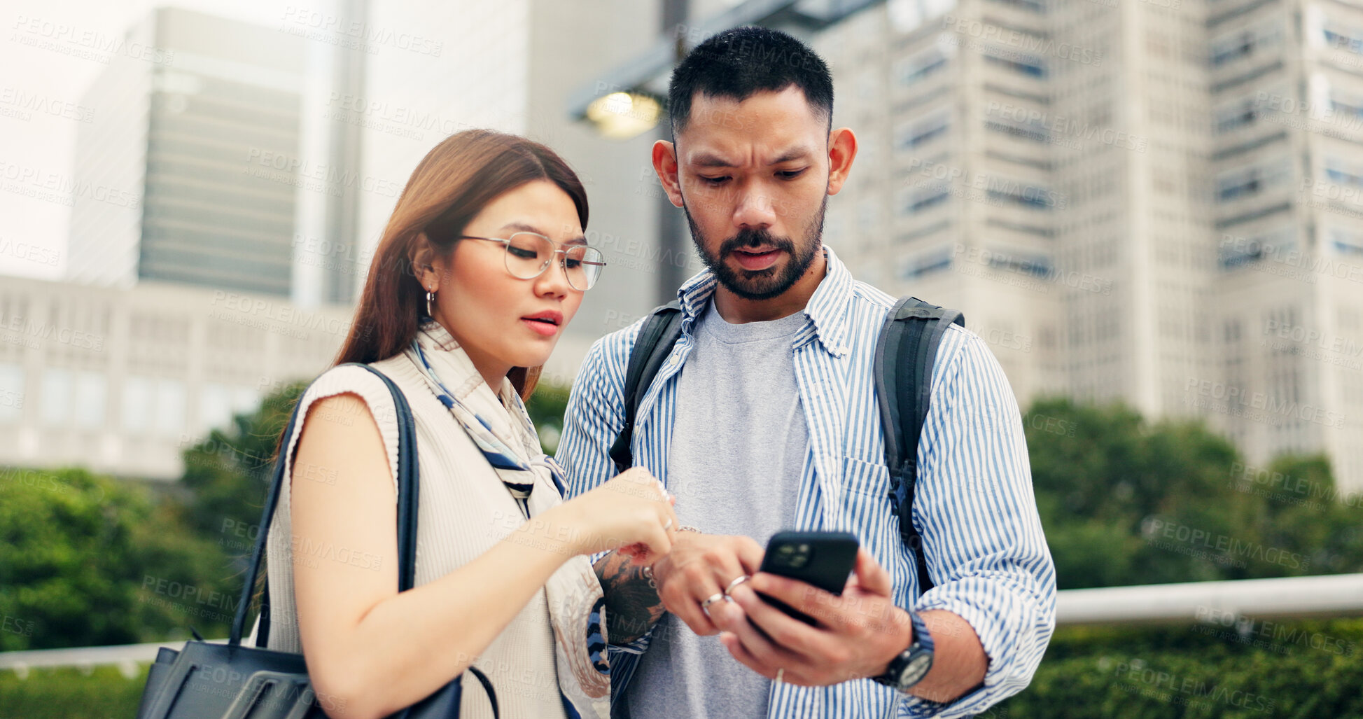 Buy stock photo Couple, phone and travel with direction in city, click and mobile app for location, landmark and help in street. People, man and woman with smartphone, talking and search on urban sidewalk in Japan