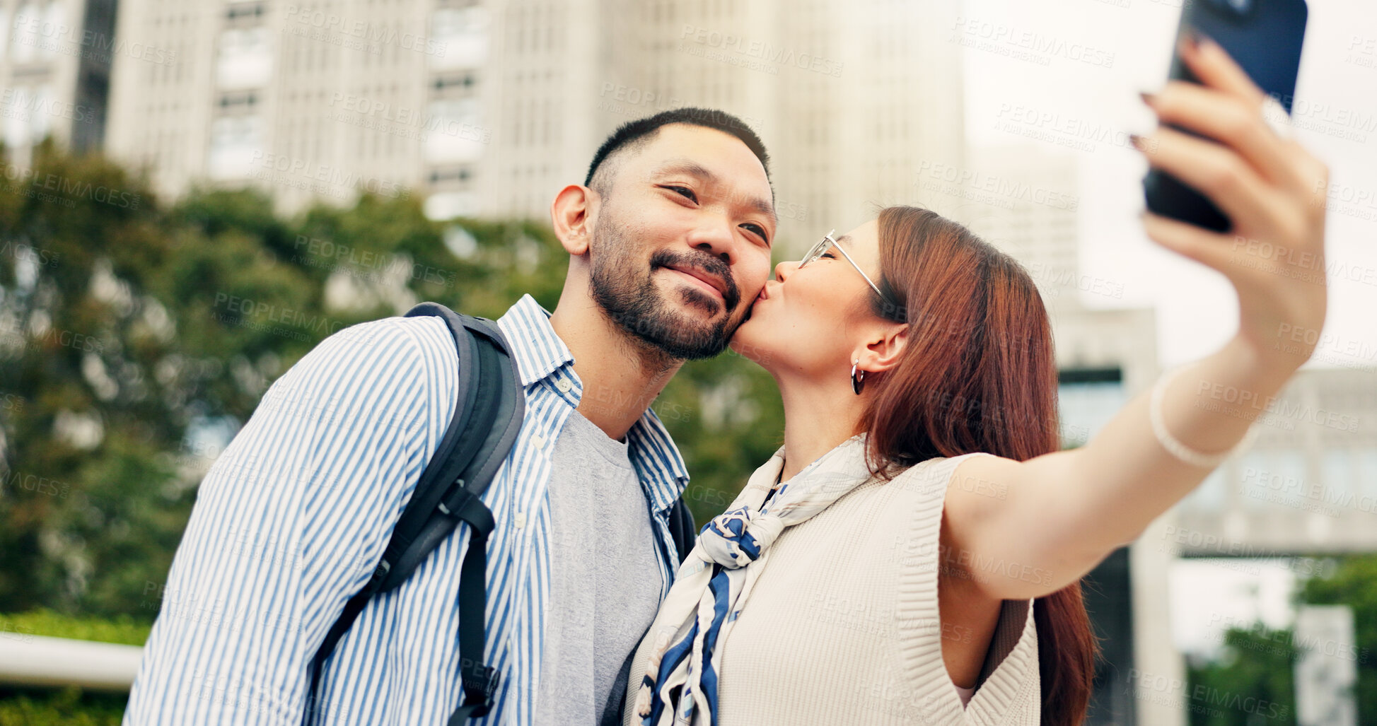 Buy stock photo Couple, kiss and selfie on trip to city of Japan, love and bonding on honeymoon vacation. Happy people, affection and support on holiday in urban town, social media update and digital photography