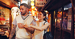 Street food, night and pointing of Japanese couple at market for culture festive, nutrition or health. Travel, shopping and cuisine with man and woman at Japan city vendor for date and holiday