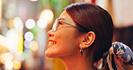 Asian woman, face and night with smile in city for travel, sightseeing or tourism on bokeh background. Japan, tourist or profile of happy female person with glasses for destination or trip in Tokyo