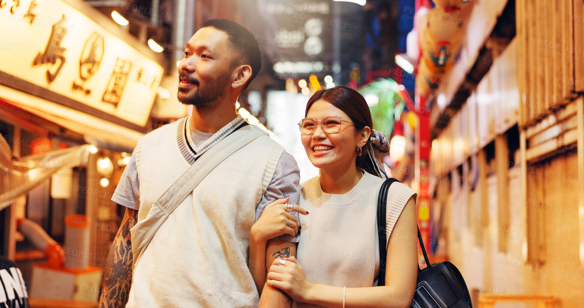 Buy stock photo Couple, night and walking street market in Japan, love and bonding on honeymoon vacation. People, security and outdoor support on holiday in town, travel together and explore culture or sightseeing