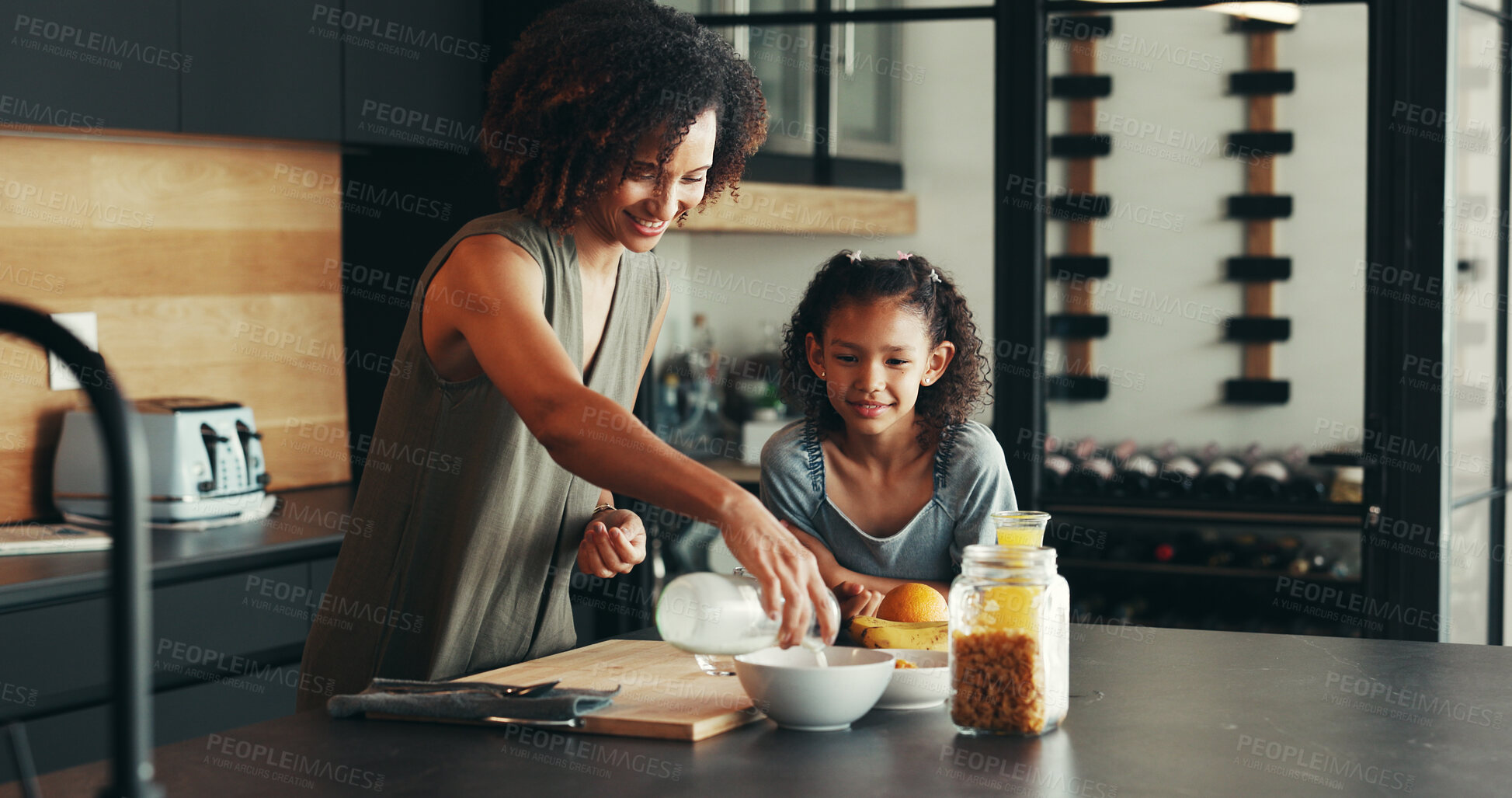 Buy stock photo Child, happy mother and pour milk for breakfast cereal, hungry or health in family home. Mom, kid and prepare food in kitchen, help and parent serve organic morning meal for nutrition, diet or growth