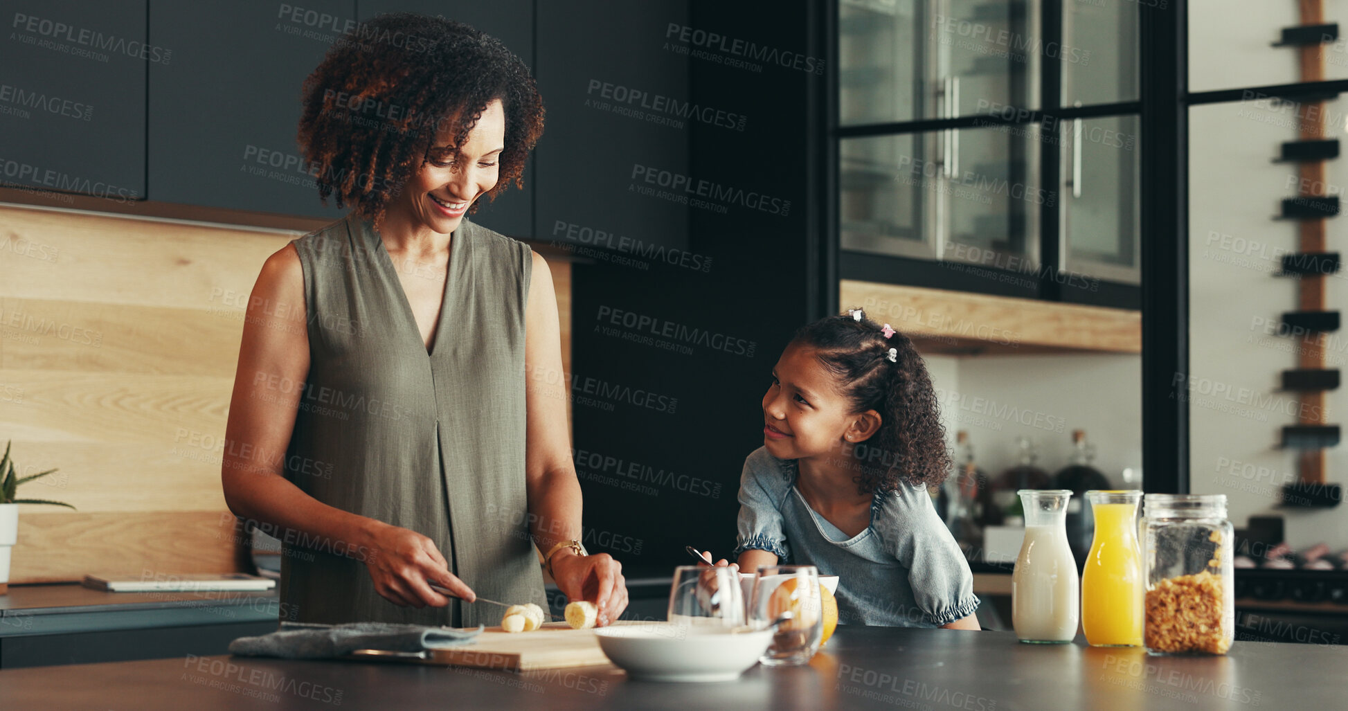 Buy stock photo Kitchen, kid and happy mother cooking breakfast, learning or chopping banana and healthy fruit in family home. Mom, child or prepare morning food, help or parent teaching girl organic recipe for diet