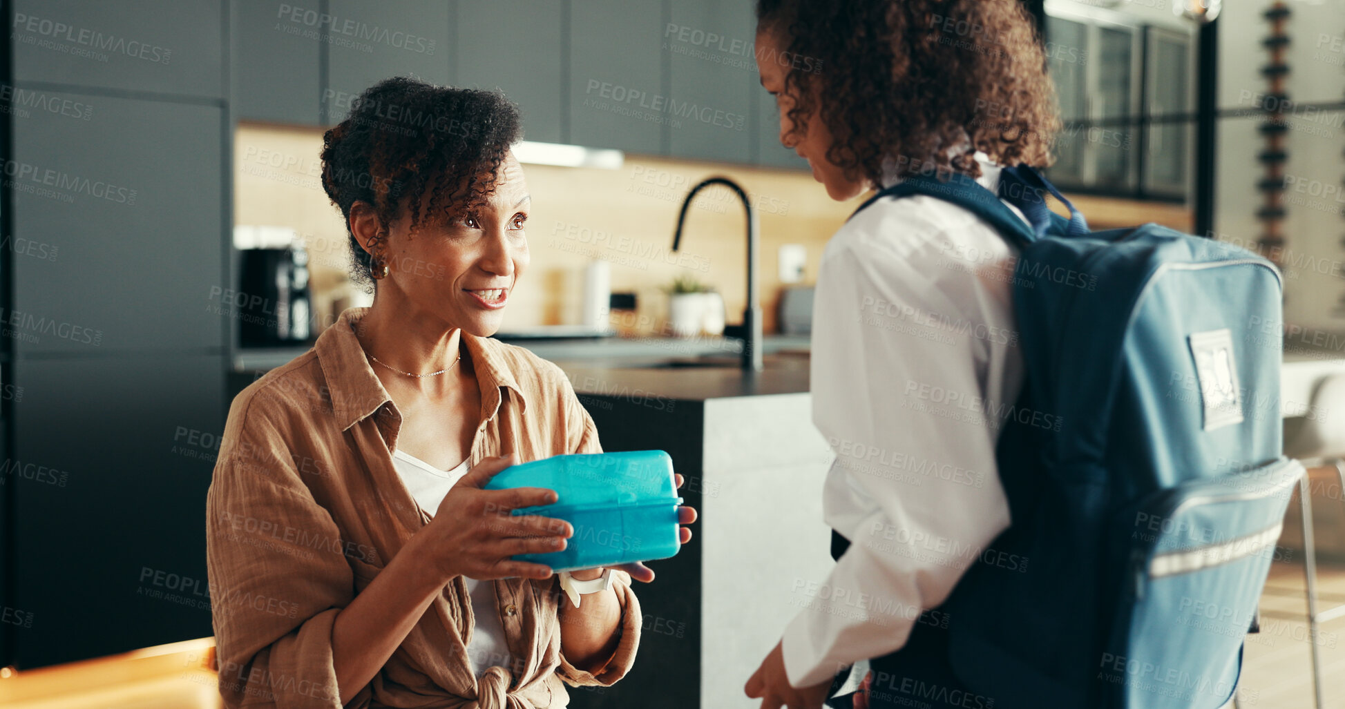 Buy stock photo Mom, girl and happy with lunchbox in home for preparing or ready for elementary education. Apartment, people and parent with kid in uniform for first day at school with food, pride and child growth