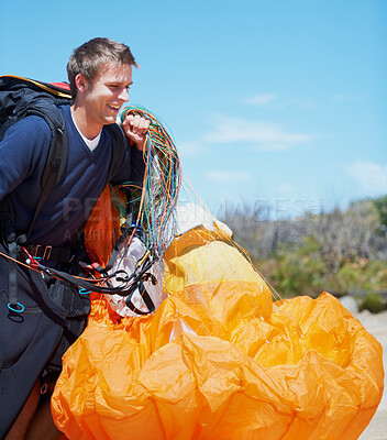 Buy stock photo Paragliding, parachute or man in nature with equipment, preparation or helmet to exercise for health. Athlete, extreme and sports with fitness for outdoor wellness, backpack and happy in countryside