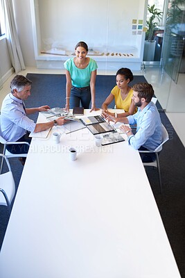 Buy stock photo Cropped shot of an attractive young businesswoman explaining her proposal to the team