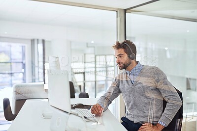 Buy stock photo Cropped shot of a handsome young businessman working in the office