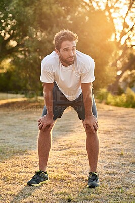 Buy stock photo Man, tired and breathing with break after running outdoor, training for sport competition and fitness for health. Morning run, sun and workout in park for race or marathon, rest and exercise fatigue