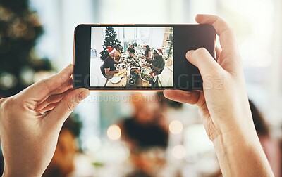 Buy stock photo Friends, hands and screen with photography at party for christmas celebration, eating food and bonding in home. Phone, people and happy memory at dining table for dinner, lunch and social gathering