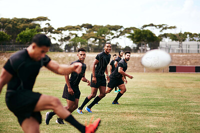 Buy stock photo Sports, kick and team of rugby players at match, training or competition with opponent. Outdoor fitness and men athletes playing game for practice, workout or exercise of skill on field at stadium