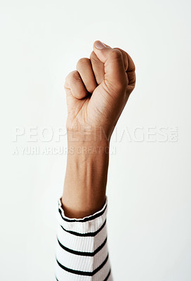 Buy stock photo Studio, person and raising fist for activism on white background with power and leadership. Fight, strength and human rights for gender based violence with support, justice and equality on protest