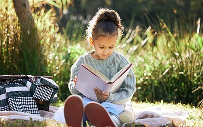 Buy stock photo Children, learning and girl in a garden with book for reading, picnic and and child development in nature. Peace, fantasy or kid with fairytale, story and literacy for studying, education or hobby