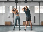 Fit, active and healthy gym couple stretching, getting ready and preparing for workout, training and exercise in wellness center. Sporty, athletic or strong man and woman warming up for weightlifting